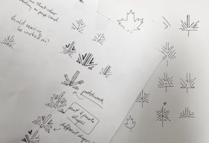 Two sketchbook pages showing a range of preliminary hand-drawn thumbnail sketches of the arrive logo in black fine line pen