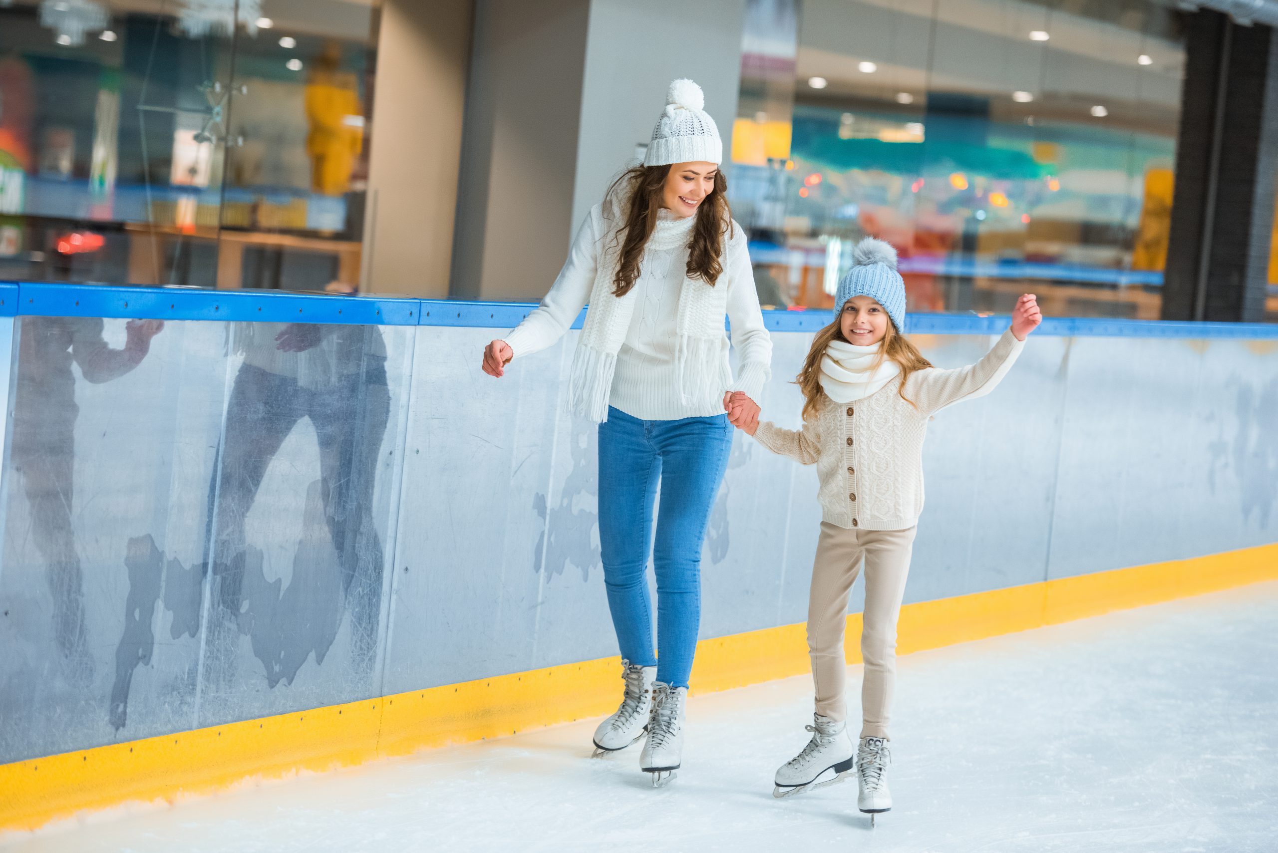 Mother and daughter skating on ice