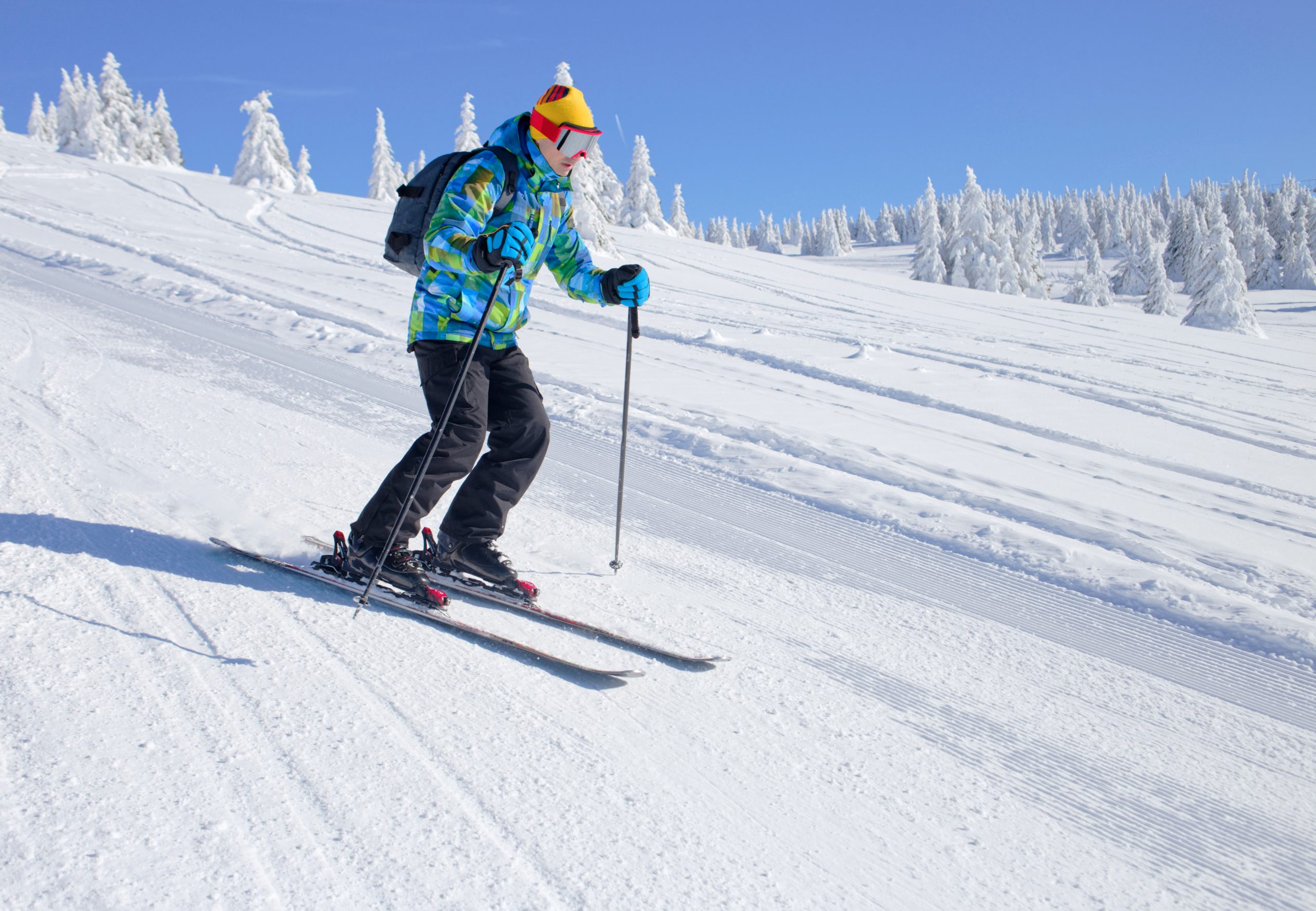 Man in blue jacket skiing