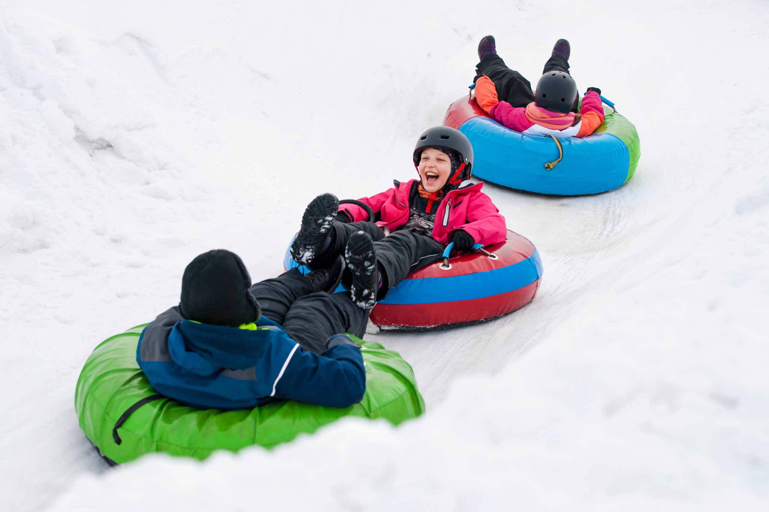 Children enjoying snow tubing