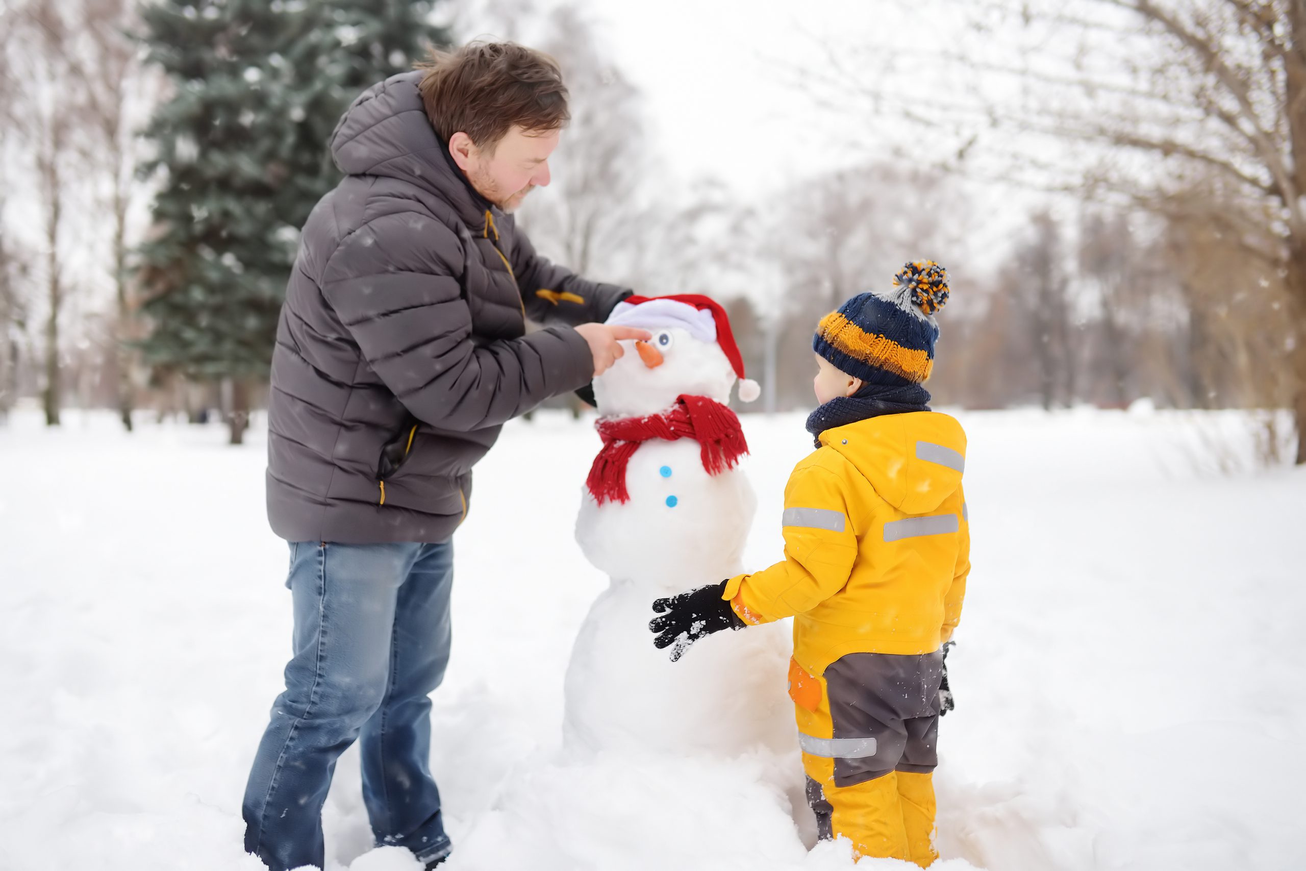 Father and son building a snowman