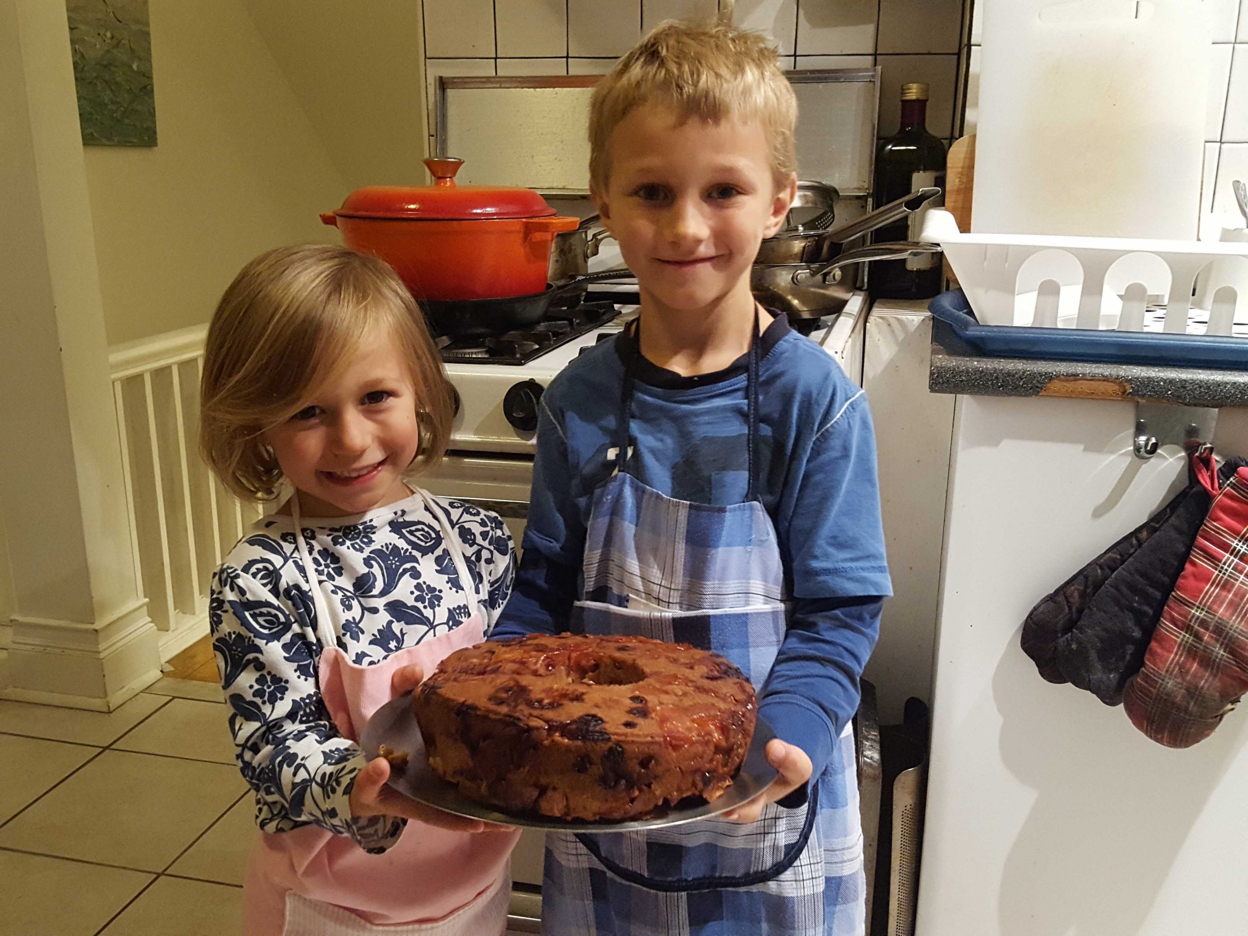 Kids holding a baked cake